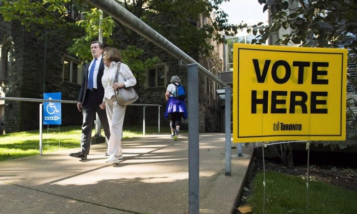 Toronto Mayor John Tory accompanies his mother Elizabeth Tory to vote at an advanced polling election station in Toronto on Oct. 10, 2018. Voters across Ontario are casting ballots on Oct. 22 to elect their next municipal governments. (The Canadian Press/Nathan Denette)