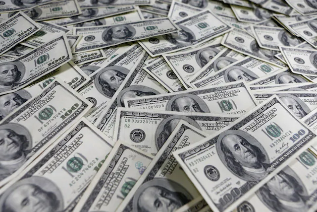 One hundred dollar notes in a photo illustration. (Lee Jae-won/Reuters)