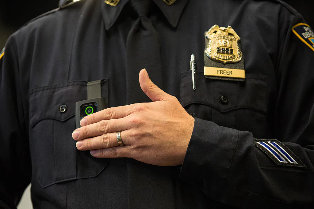 New York Police Department (NYPD) Sergeant Joseph Freer demonstrates how to use and operate a body camera during a media press conference on December 3, 2014 in New York City. (Andrew Burton/Getty Images)