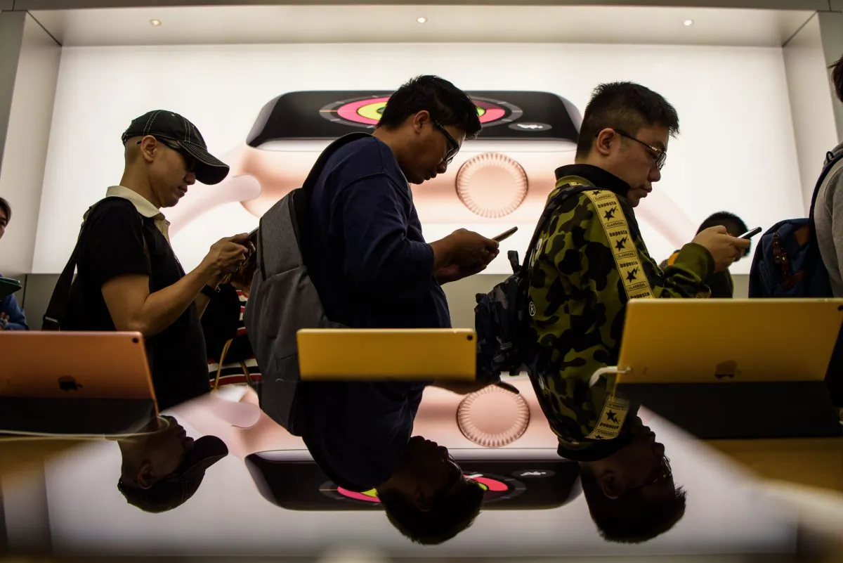 Customers queue at an Apple store to buy the iPhone X in Hong Kong on Nov. 3, 2017. ( Anthony Wallace/AFP/Getty Images)