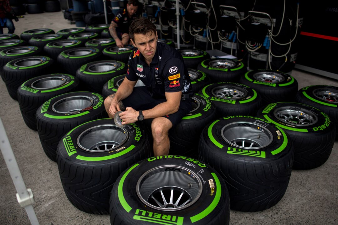 A staff member at the Formula One Chinese Grand Prix working with Pirelli tires in Shanghai on April 6, 2017. (Johannes Eisele/AFP/Getty Images)