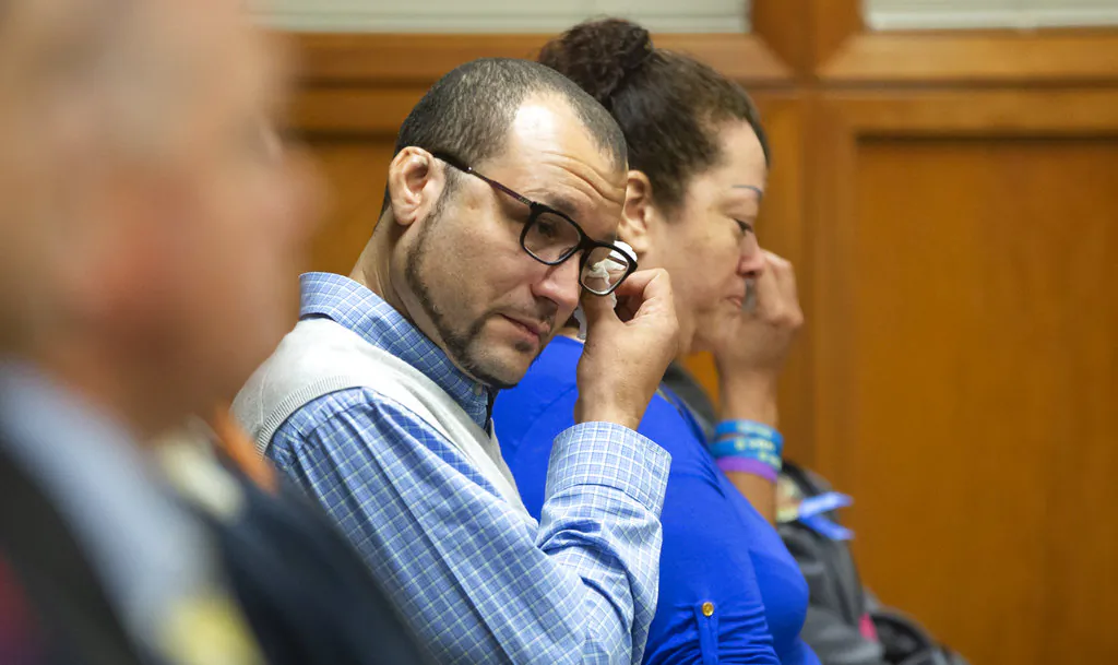 Carlo Brewer wipes away tears after Stephen Bodine was found guilty on all charges Wednesday, Oct. 24,, 2018, in Wichita, Kan., in connection with the murder of his three-year-old son Evan Brewer. (Travis Heying/The Wichita Eagle via AP)