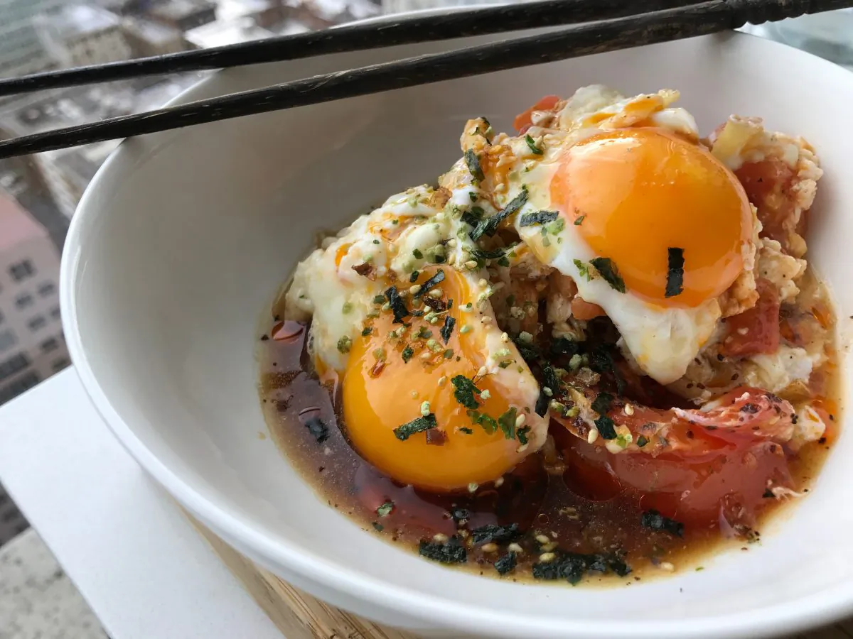 Kathy Fang's tomato enoki broth with ponzu, runny yolks, and a sprinkle of furikake. (Courtesy of Kathy Fang)