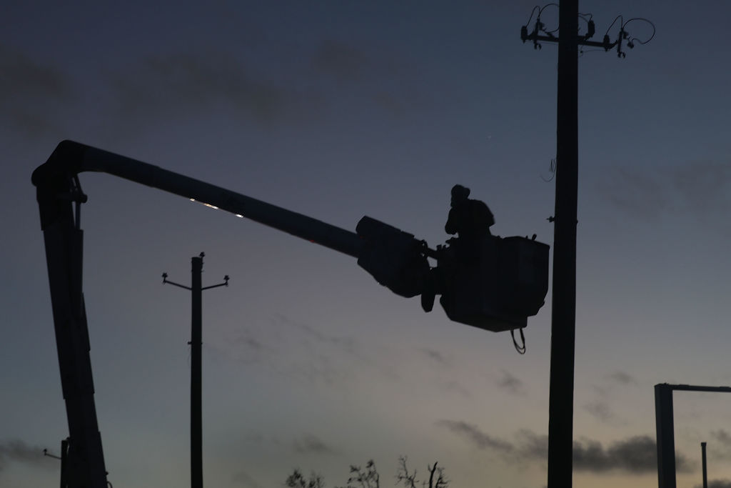 Utility worker restores power after Hurricane Michael