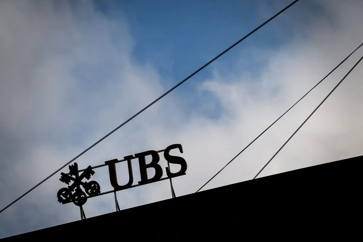 A sign of Swiss banking giant UBS is seen in silhouette in Zurich on Oct. 26. (Fabrice Coffrini /AFP/Getty Images)