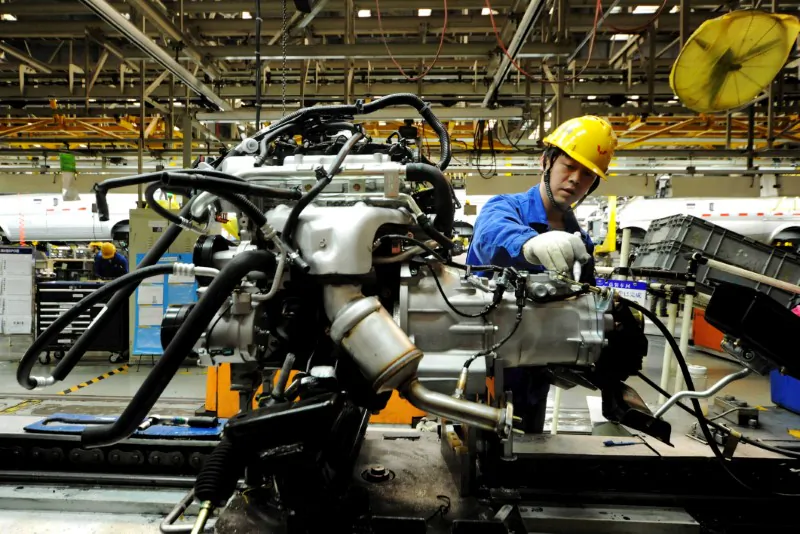 An employee works on an assembly line producing automobiles at a factory in Qingdao, Shandong Province, China on March 1, 2016. (Reuters) 