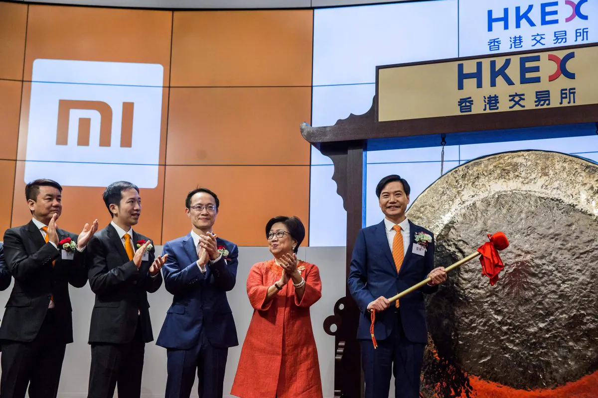 Xiaomi founder, chairman and CEO, Lei Jun (R), hits a gong at the company's initial public offering (IPO) launch on the Hong Kong Stock Exchange in Hong Kong on July 9, 2018. (ISAAC LAWRENCE/AFP/Getty Images)