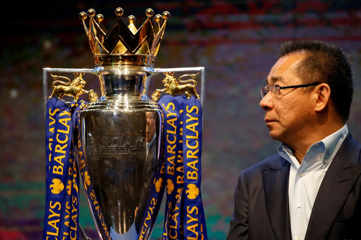 Vichai Srivaddhanaprabha, owner of football club Leicester City, stands on stage next to the club's English Premier League trophy during a meeting with the media in Bangkok, Thailand May 18, 2016. (Jorge Silva/Reuters)