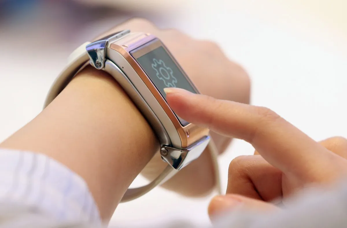 Visitors try out the new Galaxy Gear smartwatch at the Samsung stand at the IFA 2013 consumer electronics trade fair on Sept. 5, 2013 in Berlin, Germany. (Sean Gallup/Getty Images)