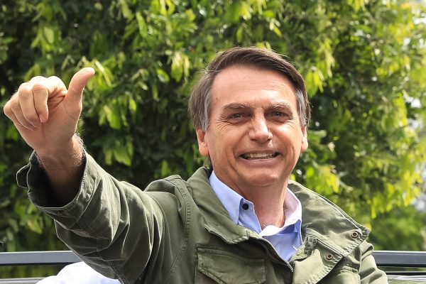 Jair Bolsonaro gestures after casting his vote.