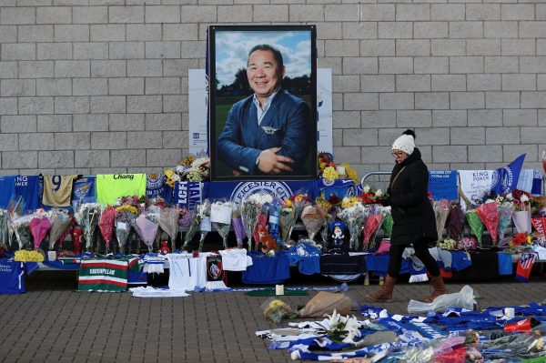 A woman places flowers outside Leicester City's King Power stadium