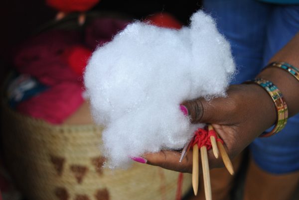 Nancy Githoitho shows the knitting wooden needles and the wool used inside the prosthetics
