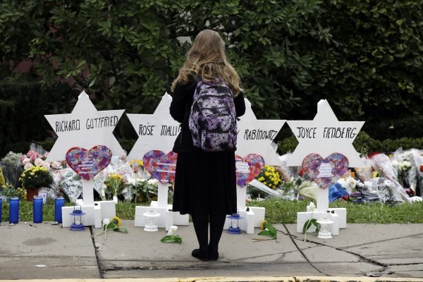 a person stands in front of a memorial