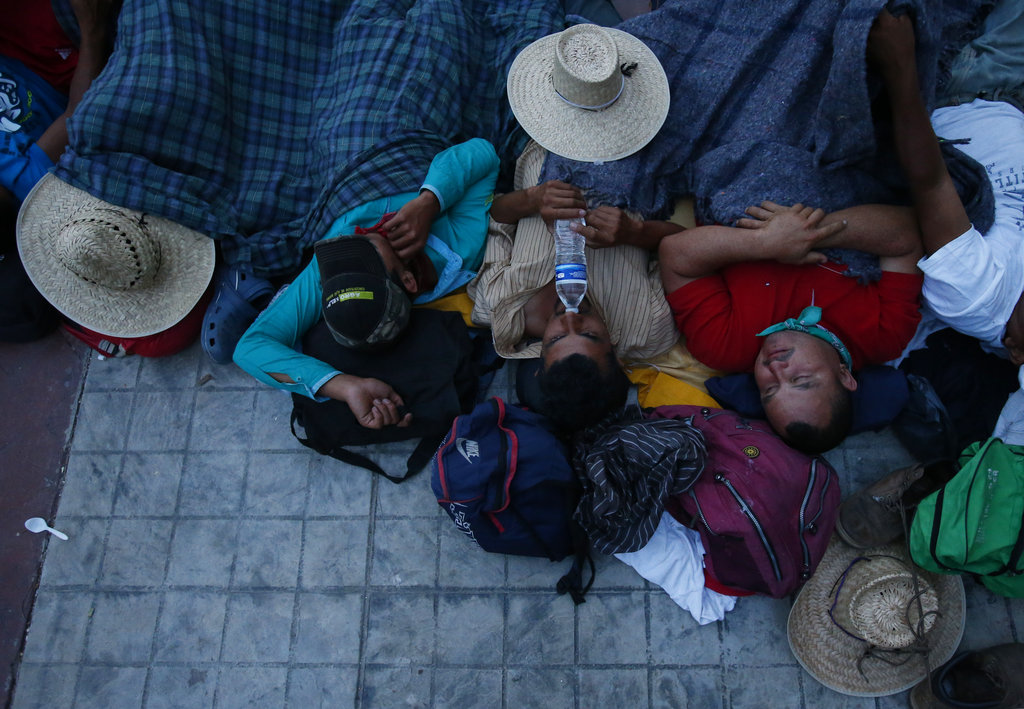 Migrants sleep together at a church in Niltepec, Mexico