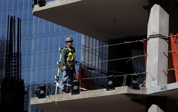 A construction worker on a floor of a building under construction in San Francisco