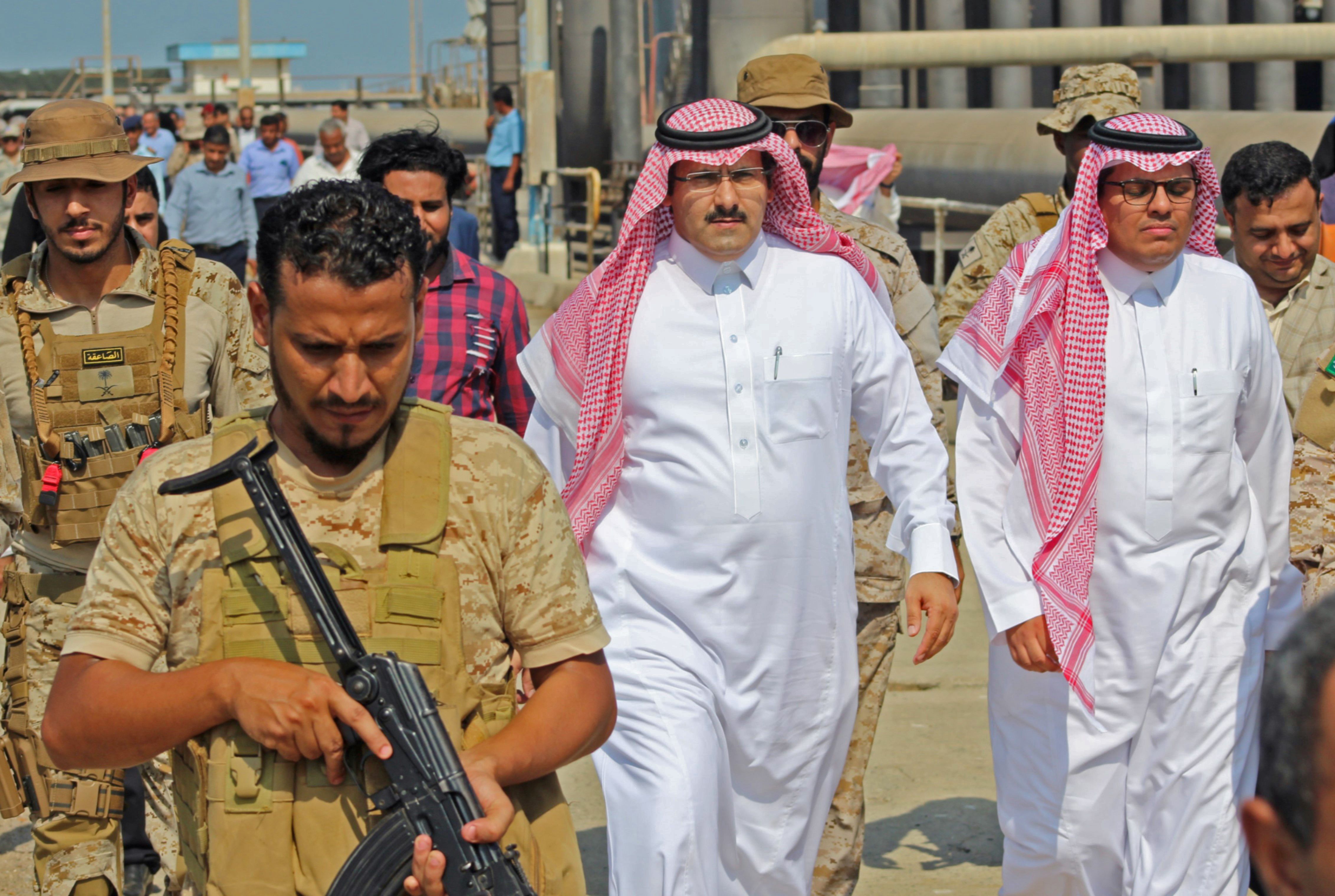 Saudi ambassador to Yemen Mohammed Said Al-Jaber (C) arrives in the southern Yemeni port of Aden to oversee an aid delivery of fuel from Saudi Arabia