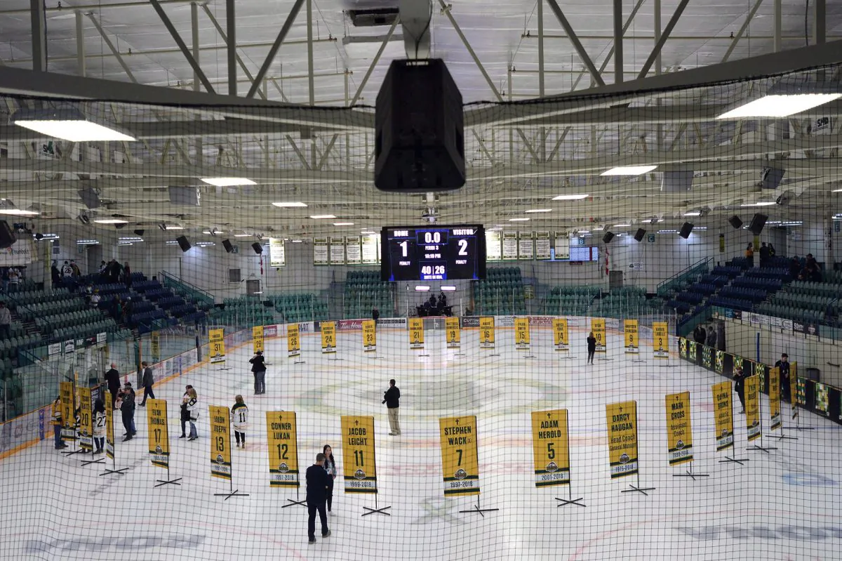 Sixteen banners in honour of the lives taken in the April bus crash are shown in the foreground and the banners for the survivors sit in the background during a tribute to the Humboldt Broncos in Humboldt, Sask., on Sept. 12, 2018. (Jonathan Hayward/The Canadian Press)