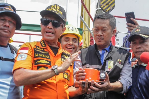 Chief of National Search and Rescue Agency Muhammad Syaugi (L) shows part of the black box of Lion Air's flight JT610 airplane, on Baruna Jaya ship, in the north sea of Karawang