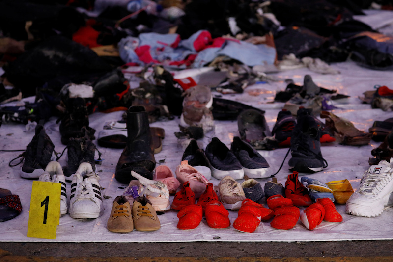 Recovered shoes believed to be from the crashed Lion Air flight JT610 are laid out at Tanjung Priok port in Jakarta