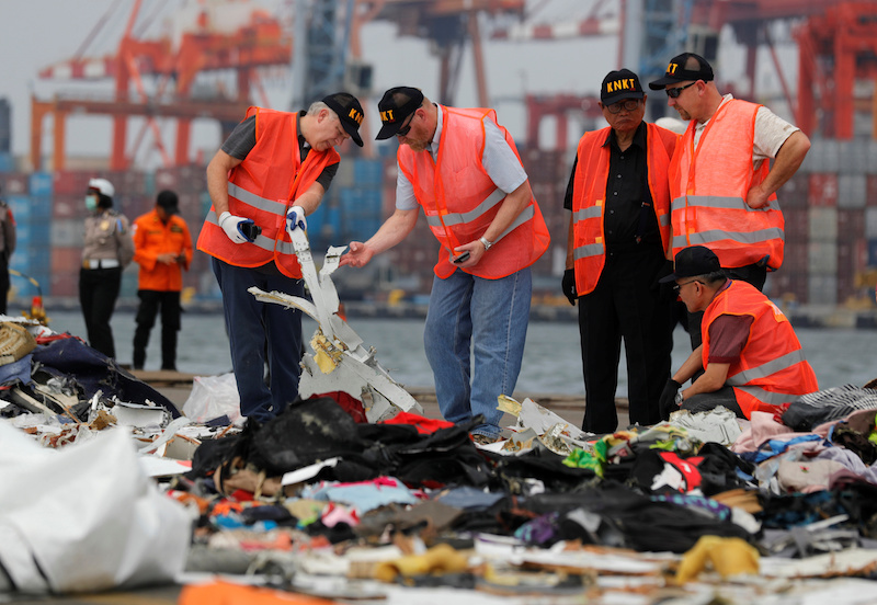 Personnel from National Transportation Safety Board examine debris from Lion Air flight JT610 at Tanjung Priok port in Jakarta