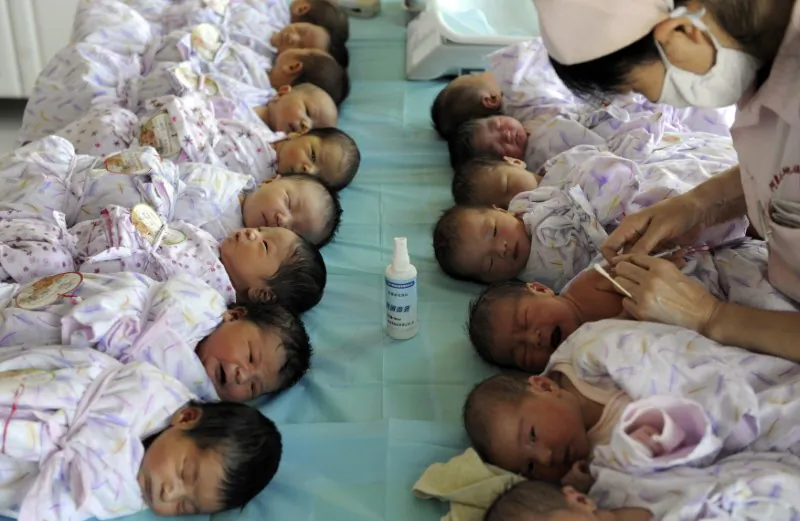 Newly born babies receive vaccines at a hospital in Aksu, Xinjiang Uyghur Autonomous Region on Aug. 10, 2012. (Reuters)