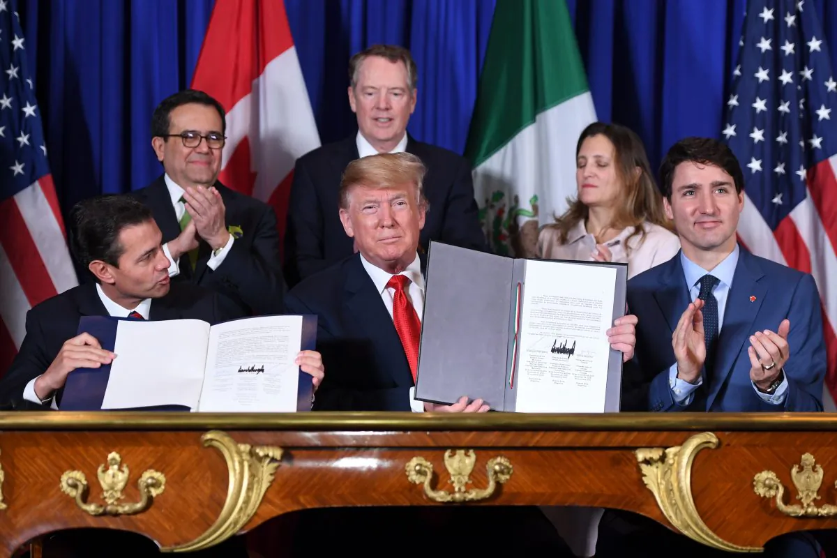 Mexico's President Enrique Pena Nieto (L), U.S. President Donald Trump (C) and Canadian Prime Minister Justin Trudeau, sign the new North American trade agreement in Buenos Aires, on the sidelines of the G20 Leaders' Summit on Nov. 30, 2018. (Saul Loeb/AFP/Getty Images)