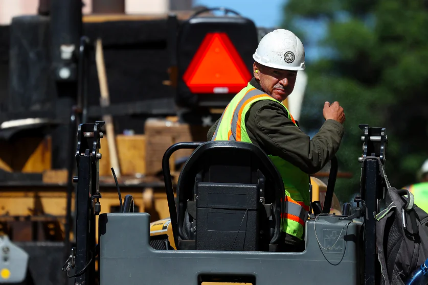 A construction worker operates a steam roller while paving a road in San Francisco on Oct. 5, 2018. (Justin Sullivan/Getty Images)
