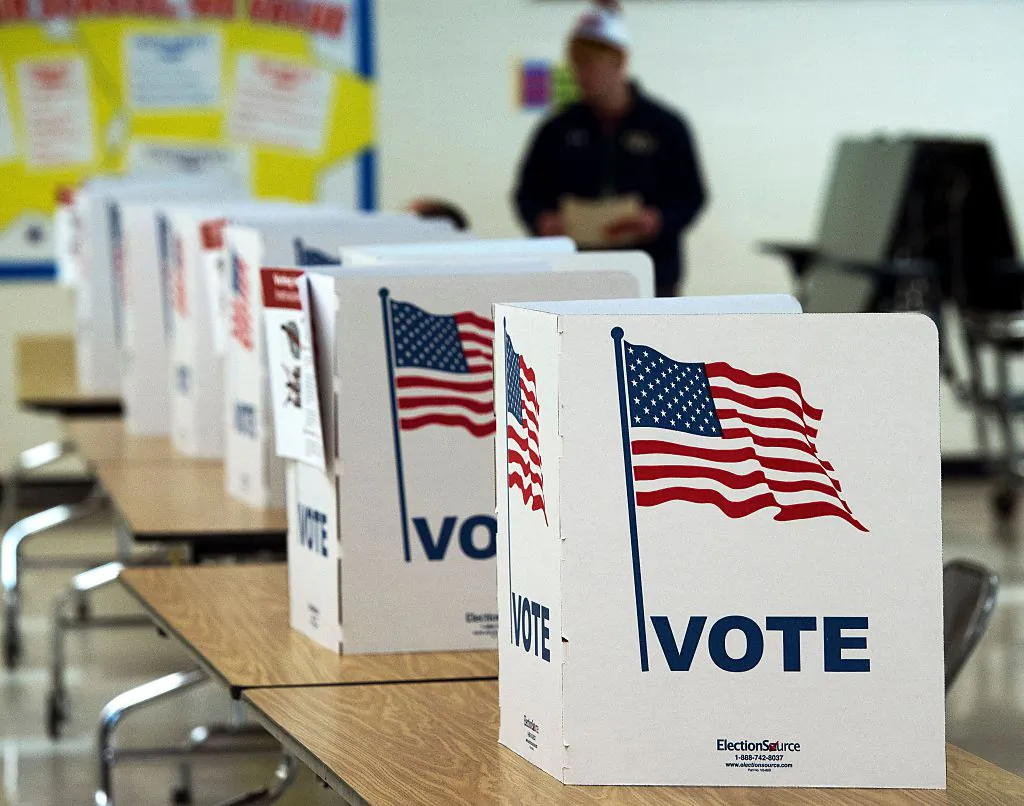 A man walks to use a voting booth at one of the Virginia primary election polling stations at Colin Powell Elementary School in Centreville, Va., on March 1, 2016. (Paul J. Richards/AFP/Getty Images)