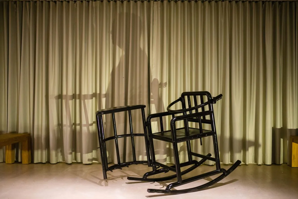 This photo illustration shows the shadow of a person and a 'tiger chair', a restraining chair reportedly used by Chinese authorities when questioning detainees, on a stage in Hong Kong on Nov. 2, 2018. An art show by Chinese political cartoonist Badiucao, whose real-time image was going to be projected onto an avatar sitting in the chair, was cancelled due to safety concerns with organizers citing "threats made by Chinese authorities relating to the artist." (Anthony Wallace/ AFP/Getty Images)