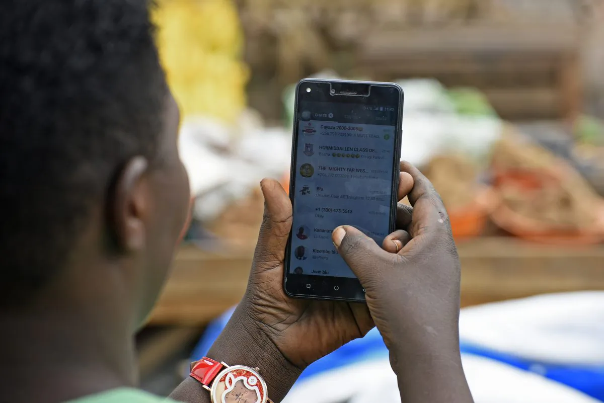 A woman uses WhatsApp on her phone in Kampala, Uganda, on July 5, 2018. (Isaac Kasamani/AFP/Getty Images)