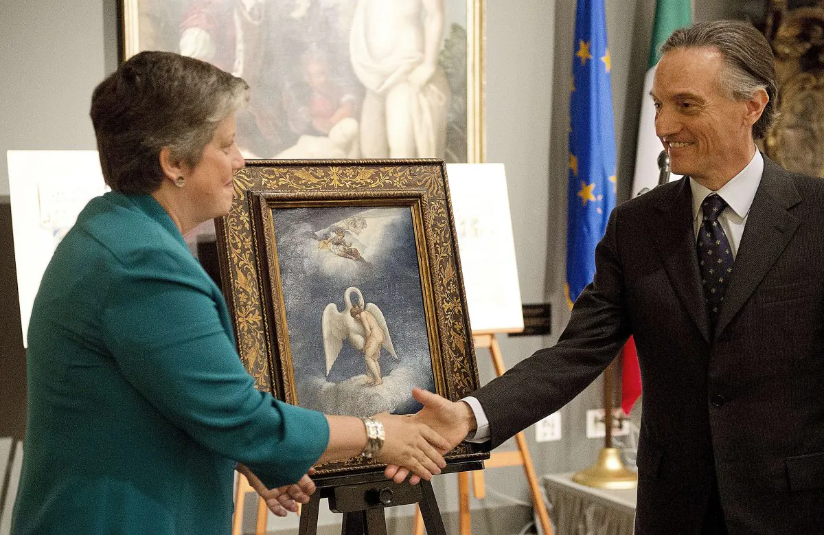 U.S. Secretary of Homeland Security Janet Napolitano and Italian Ambassador to the U.S. Claudio Bisogniero unveil a Renaissance painting by Lelio Orsi called "Leda and the Swan" during a repatriation ceremony in Washington DC on April 26, 2012. (Jim Watson/AFP/Getty Images)
