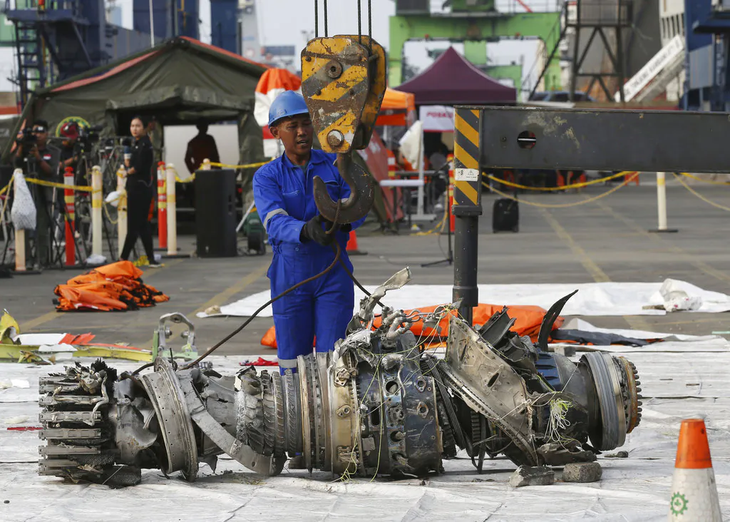 Officials move an engine recovered from the crashed Lion Air jet for further investigation in Jakarta, Indonesia, on Nov. 4, 2018. (AP Photo/Achmad Ibrahim)
