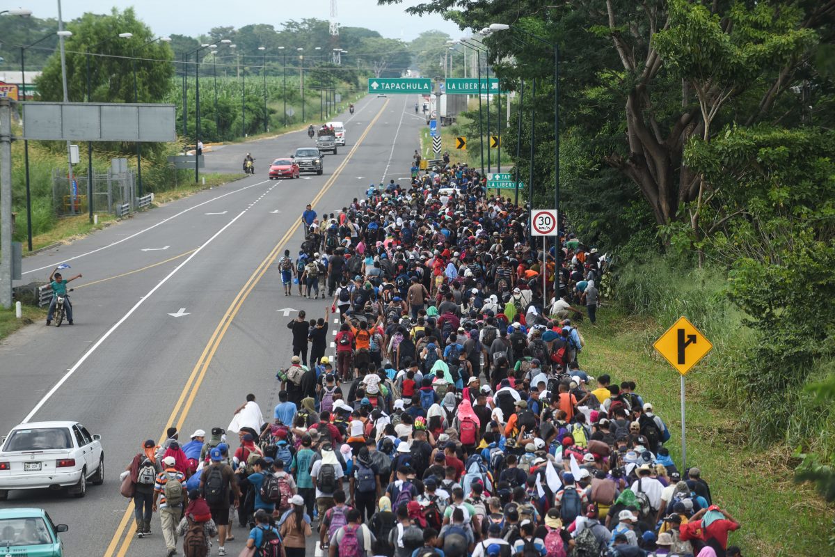 Migrants in a caravan heading to the United States walk alongside the route between Ciudad Hidalgo and Tapachula in Mexico.