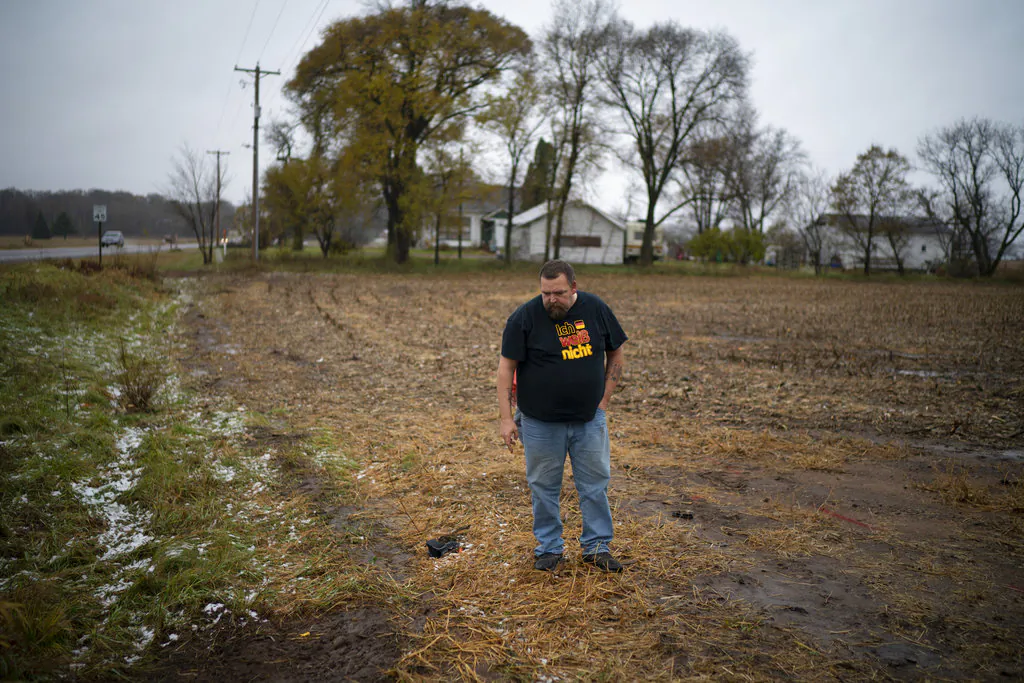 A relative of the adult victim struck and killed by a vehicle Saturday looks at the path he thought the truck took when it veered off Wisconsin County Hwy. P, Nov. 4, 2018. (Jeff Wheeler/Star Tribune via AP)
