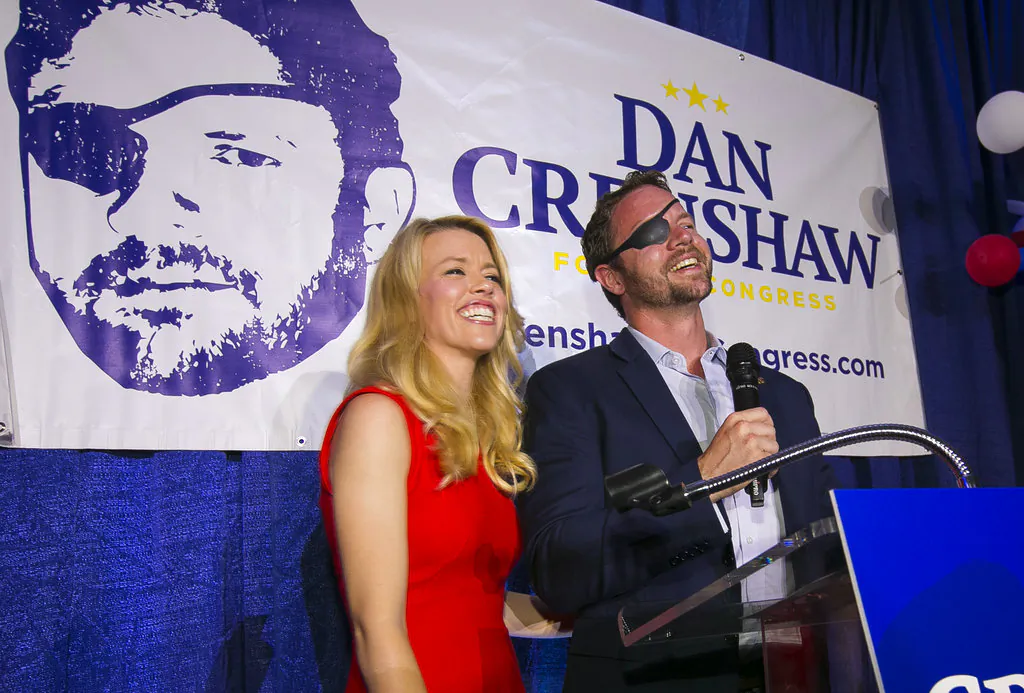 In this Tuesday, May 22, 2018, file photo, Republican congressional candidate Dan Crenshaw reacts to the crowd with his wife, Tara, as he comes on stage to deliver a victory speech during an election night party at the Cadillac Bar, in Houston, Texas. (Mark MulliganHouston Chronicle via AP, File)