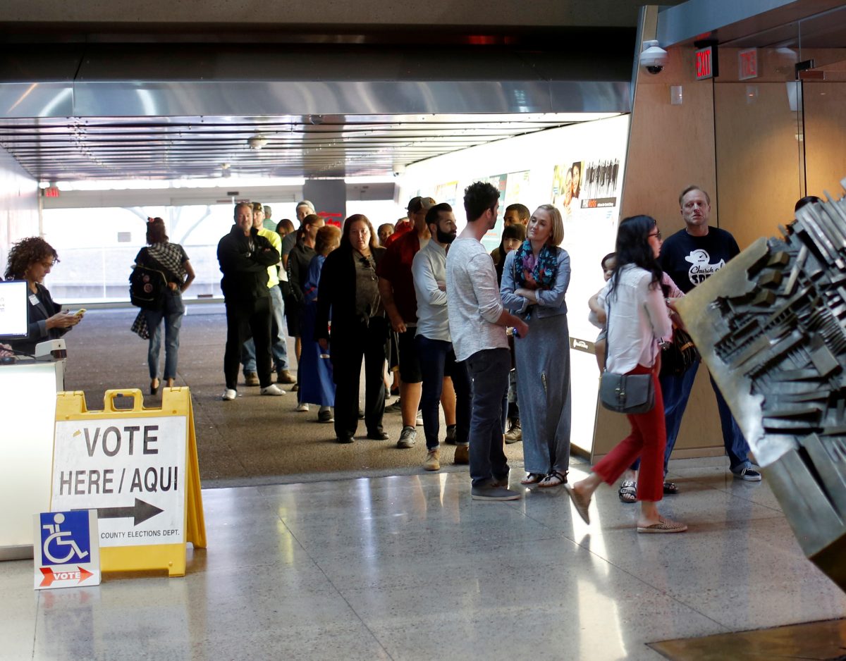 Voters wait to cast their midterm elections ballots at Burton Barr Library, a polling station in Phoenix.