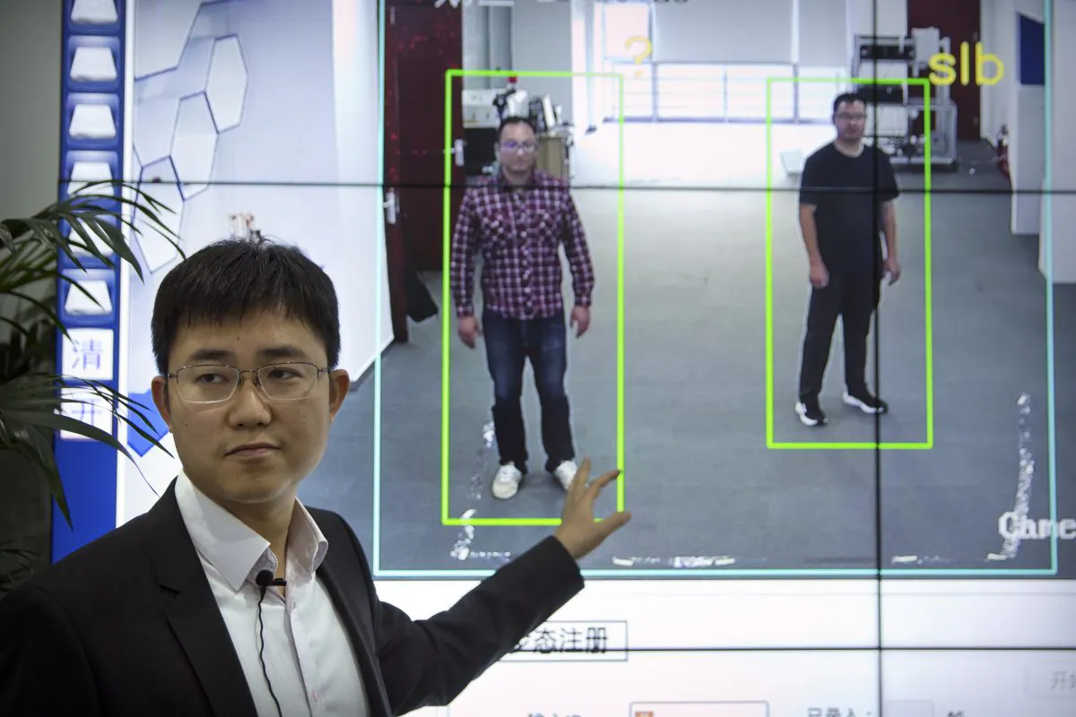 Huang Yongzhen, CEO of Watrix, demonstrates his firm's gait recognition software at his company's offices in Beijing on Oct. 31, 2018. The software recognizes people by their body shape and how they walk, which enabls identification of people when faces are hidden from cameras. Already used by police on the streets of Beijing and Shanghai, “gait recognition” is part of a major push to develop artificial-intelligence and data-driven surveillance across China, raising concerns about how far the technology will go. (Mark Schiefelbein/AP)
