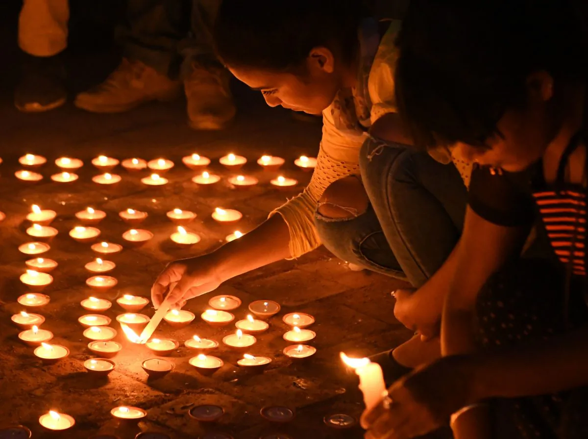 Nepali youth light candles during a vigil in memory of the victims of acid attacks in Kathmandu on Sept. 27, 2018. (Prakash Mathema/AFP/Getty Images)