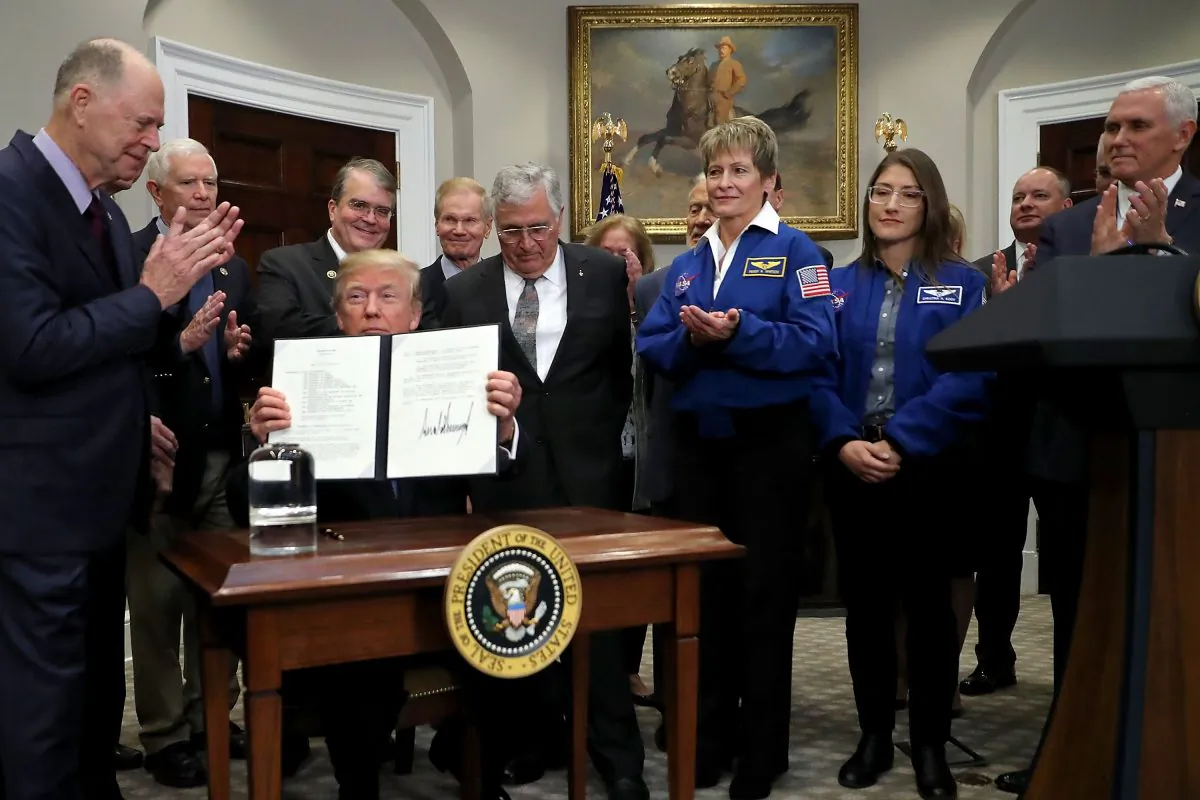 President Donald Trump holds up 'Space Policy Directive 1' after signing it during a ceremony at the White House Dec. 11, 2017. (Chip Somodevilla/Getty Images)