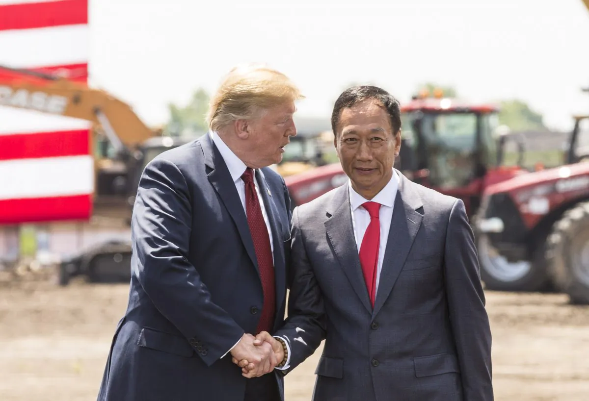 President Donald Trump (L) shakes hands with Foxconn Chairman Terry Gou at the groundbreaking for the Foxconn Technology Group computer screen plant in Mt Pleasant, Wisconsin, on June 28, 2018. (Andy Manis/Getty Images)