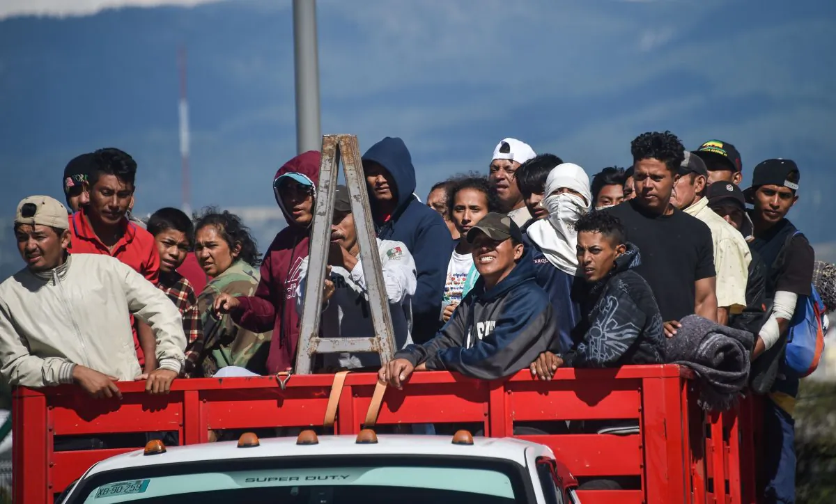 Migrants from Central American countries -mostly Hondurans- heading in a caravan to the U.S., on board a truck at the Mexico City-Puebla highway in San Marcos' toll, Mexico, on Nov. 5, 2018. (Rodrigo Arangua/AFP/Getty Images)
