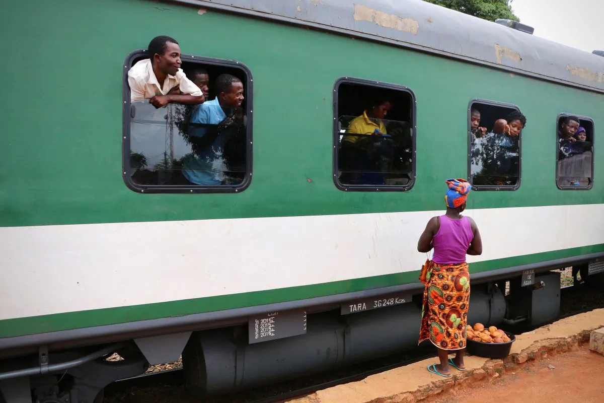 Street and food vendors approach passengers on a train in northern Mozambique on March 10, 2018.   Malawian NGOs and opposition parties are asking why an election kit for the country’s elections next year were found on a train in neighboring Mozambique. (Adrien Barbier/AFP/Getty Images)