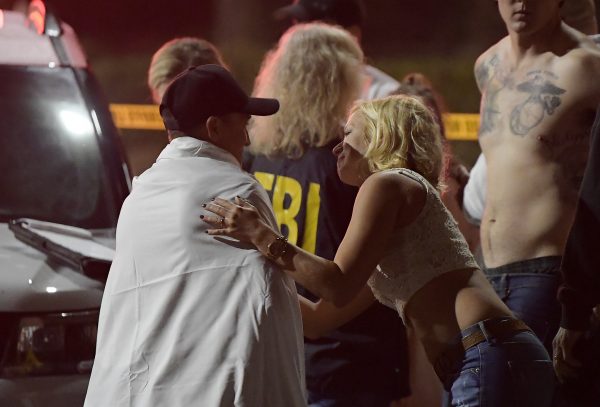 people comfort each other outside the Thousand Oaks mass shooting scene