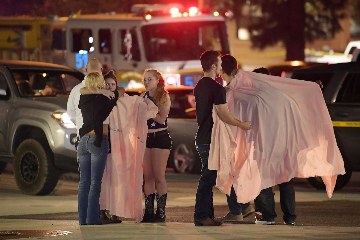 people comfort each other after the mass shooting at Thousand Oaks