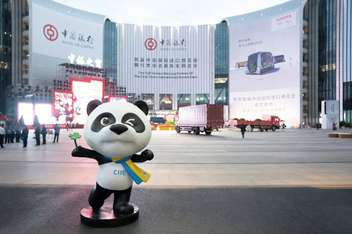 A statue of the China International Import Expo (CIIE)'s mascot is placed in front of a building hanging advertisement of Bank of China, at the venue for the expo in Shanghai, China on Nov. 2, 2018. (Reuters) 