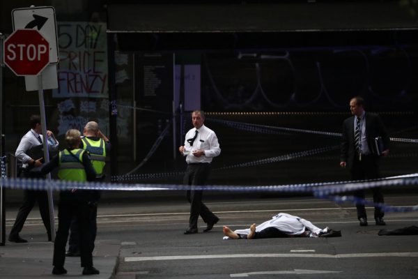 the body of a victim lies on the ground