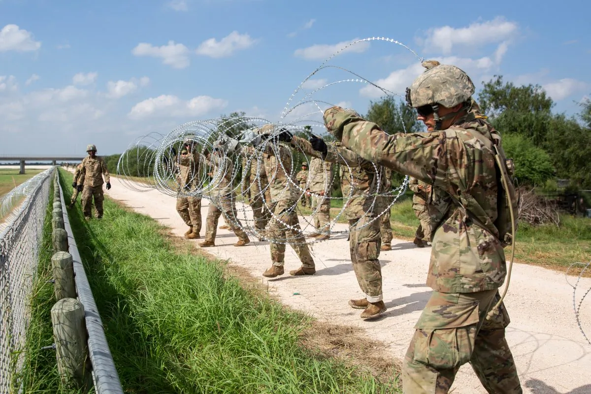 The U.S. military installs concertina wire on the levee behind Granjeno in Texas, just north of the U.S.-Mexico border on Nov. 7, 2018. (Samira Bouaou/The Epoch Times)