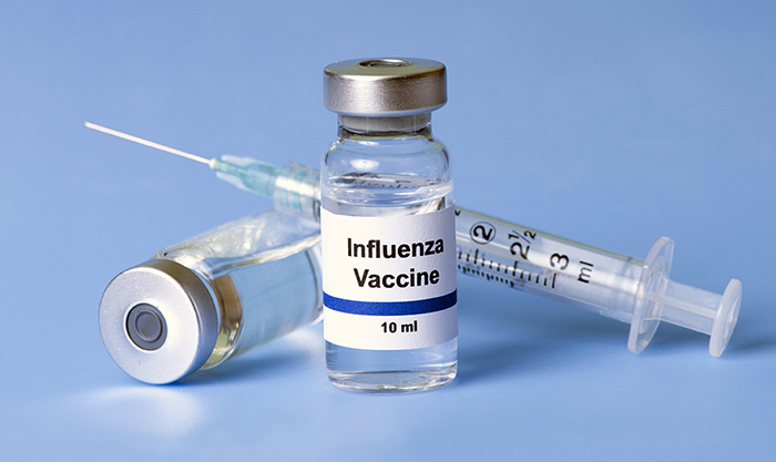 Influenza vaccine and syringe (Stock photo)