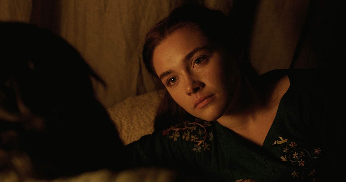 Florence Pugh reclining on bed
