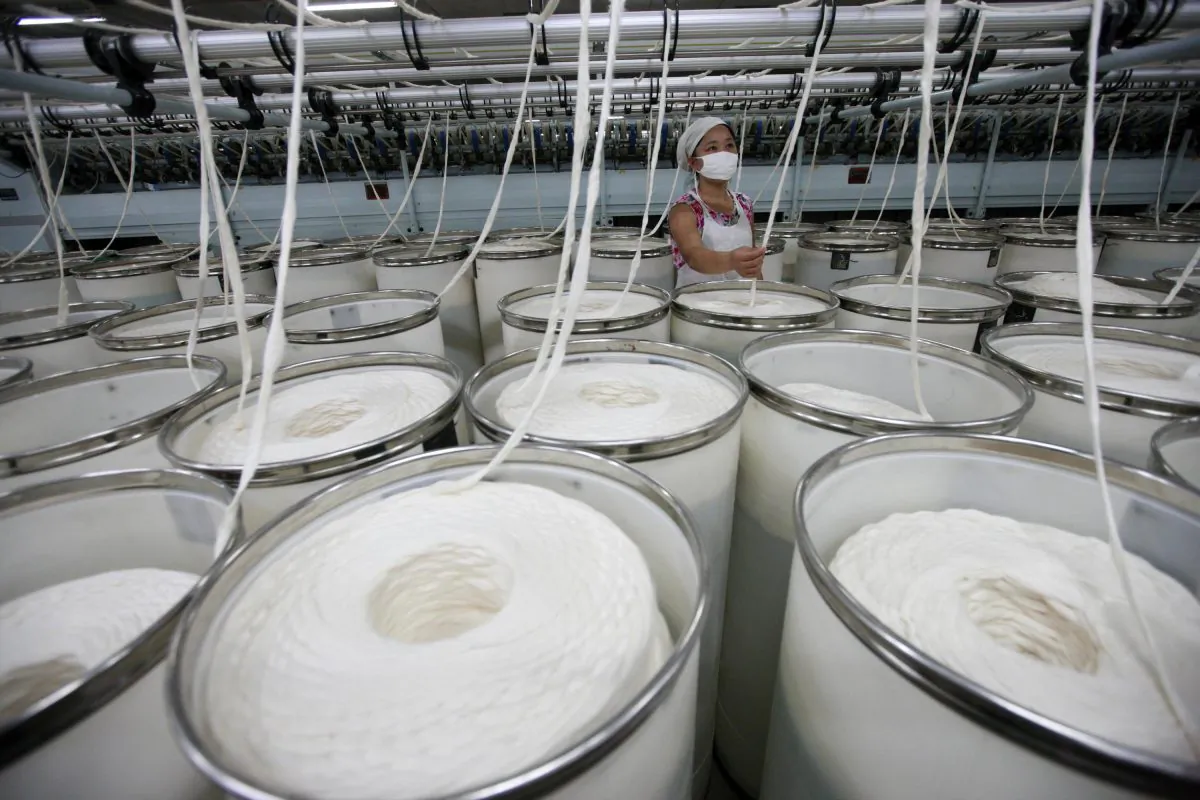 In this photo taken on October 22, 2011 a worker operates machines for making yarn at a textile factory in Huaibei, east China's Anhui province. (STR/AFP/Getty Images)